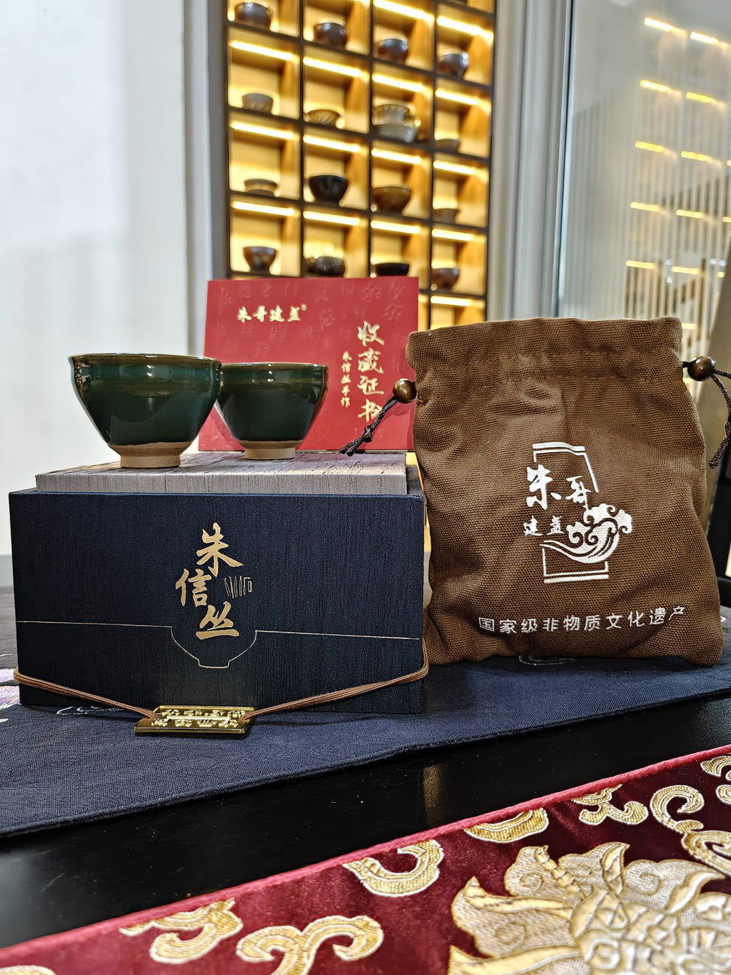 Teal green JianZhan tea cup pair with navy gift box, linen pouch and collector's certificate