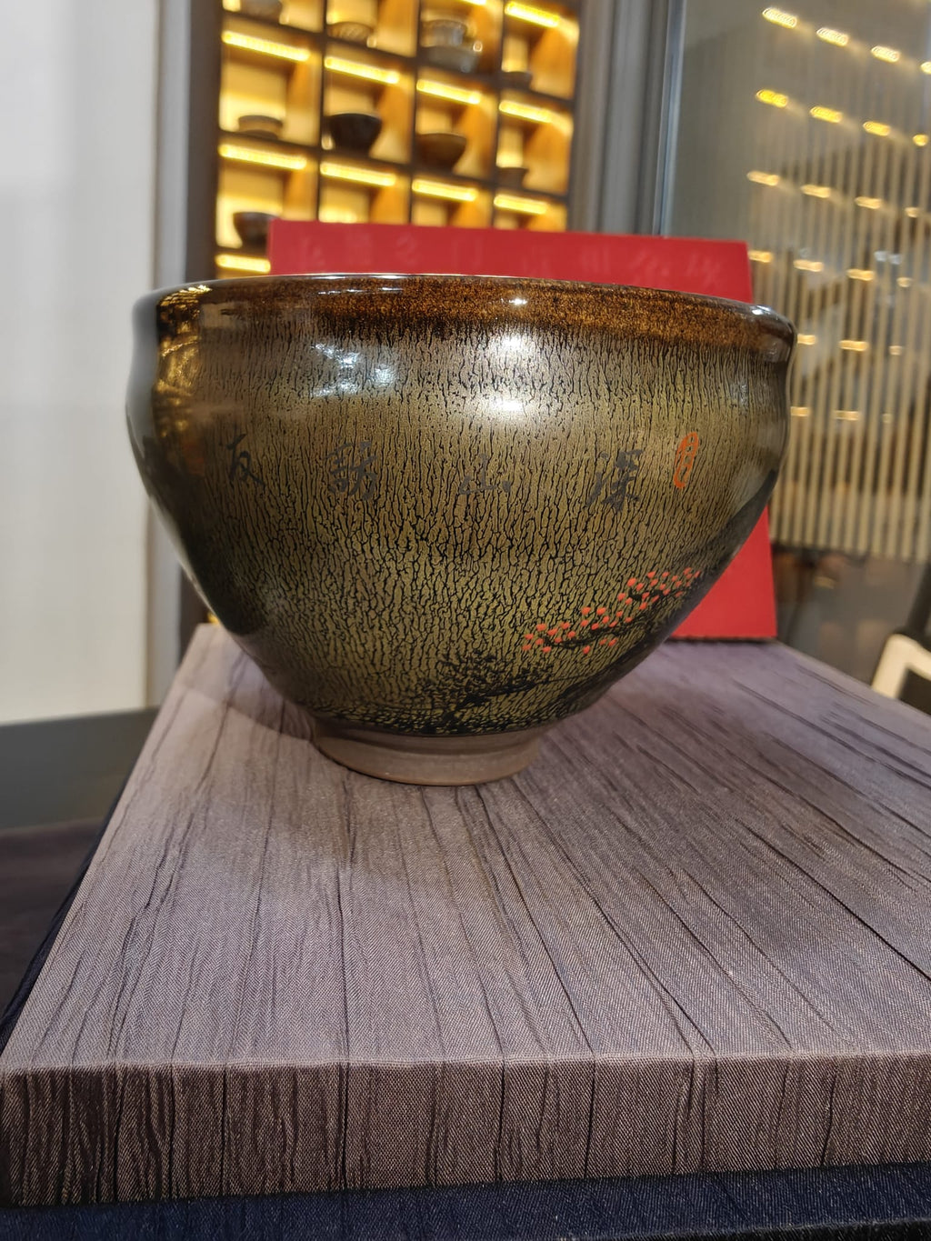 Mountain landscape JianZhan tea bowl side view with red plum motif