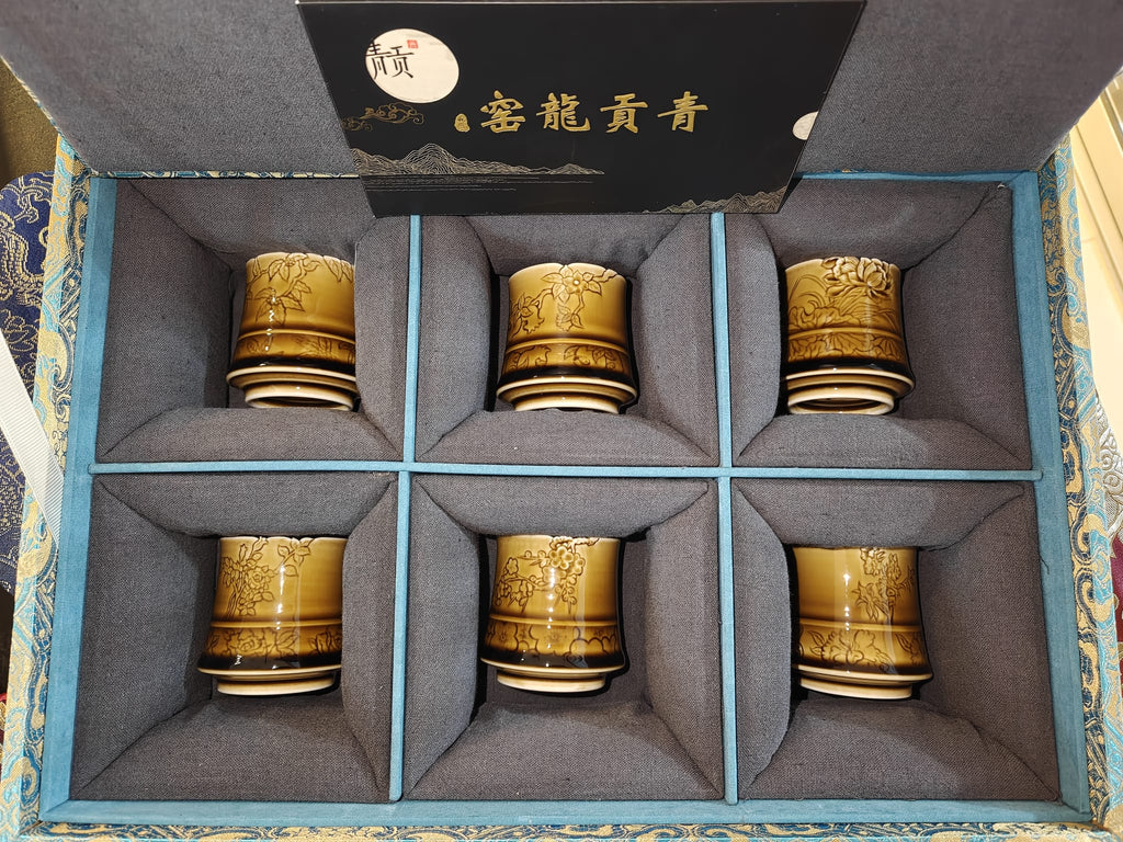 Amber gold carved floral 6 cups displayed with 青贡龙窑 gift box